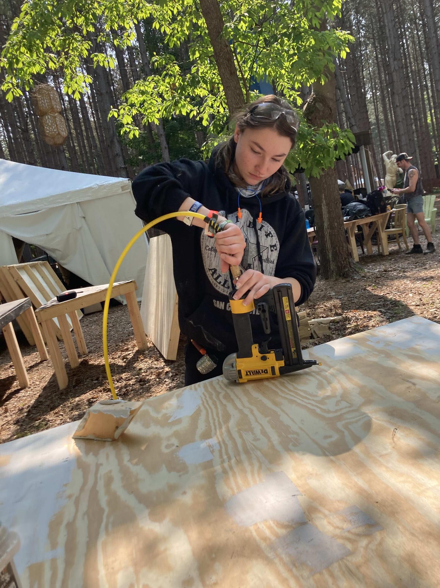 Victoria working with tools at Electric Forest